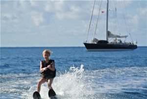 Kids waterskiing in front of Pacific Wave